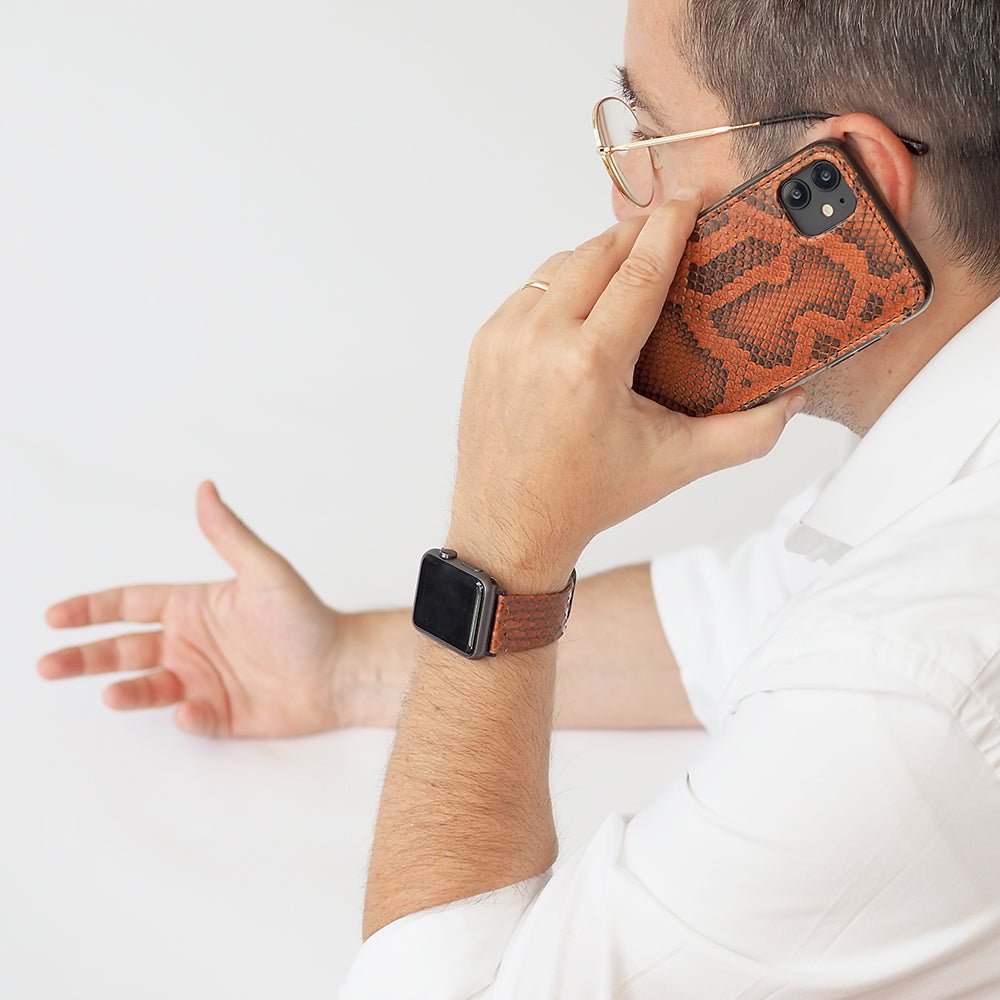 gold  python strap apple watch with black adapters and buckle contextual image